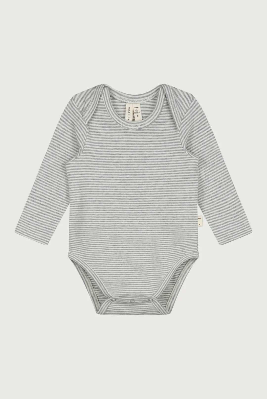 A long-sleeve baby bodysuit with fine horizontal gray and white stripes, laid flat against a light gray background.
