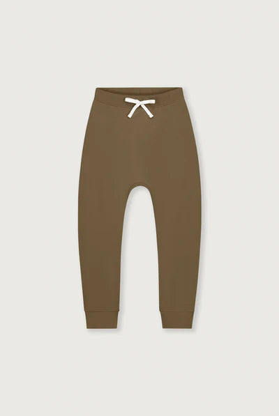 A pair of solid brown jogger-style pants with a white drawstring at the elastic waistband, shown flat against a light gray background.