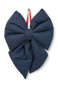 A large padded bow ornament featuring a blue and brown striped pattern, with a red hanging loop at the top, shown against a plain white background.