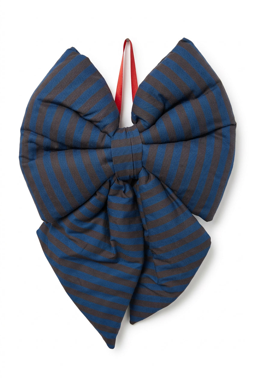 A large padded bow ornament featuring a blue and brown striped pattern, with a red hanging loop at the top, shown against a plain white background.