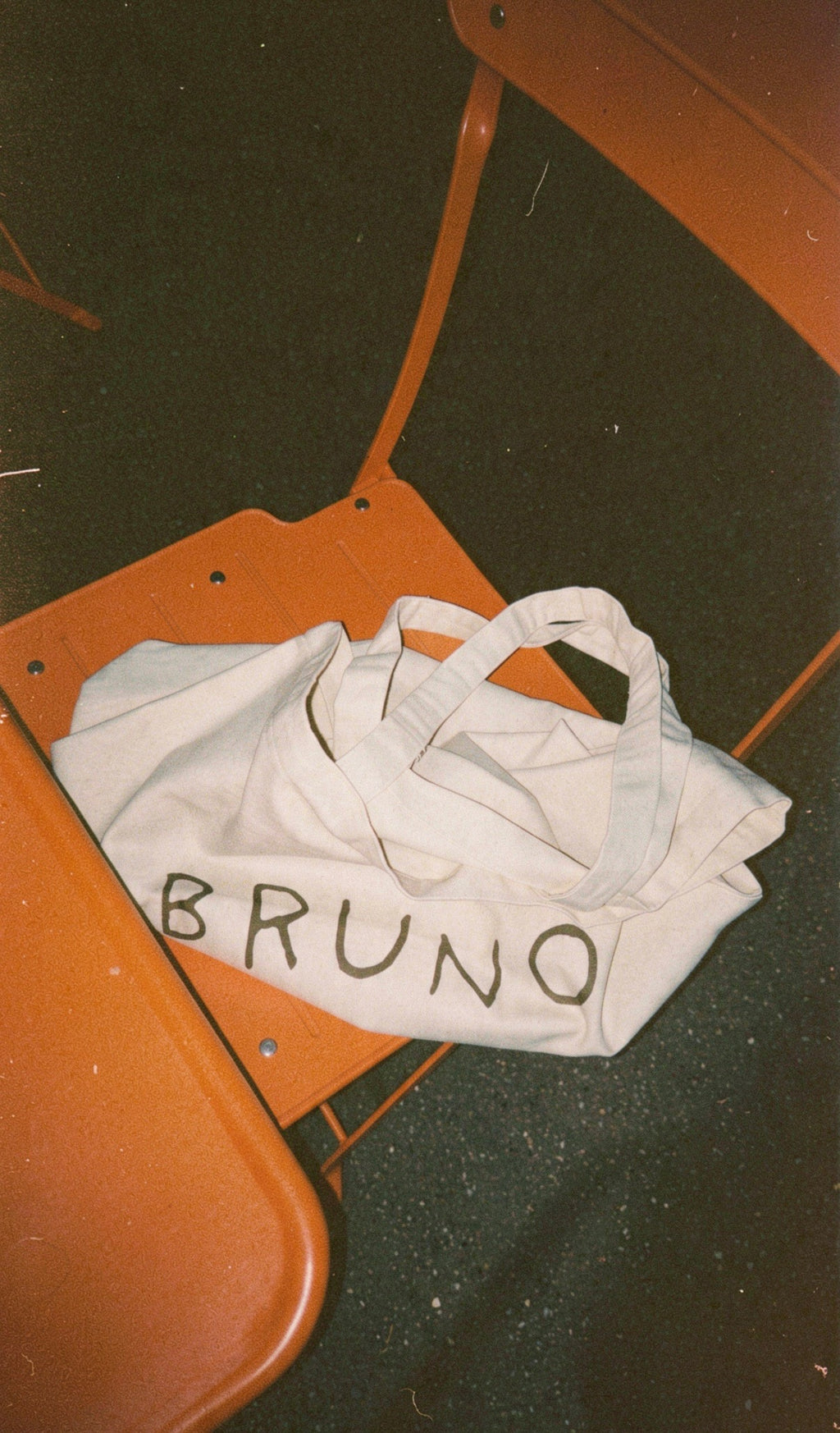 bruno canvas bag on orange chair