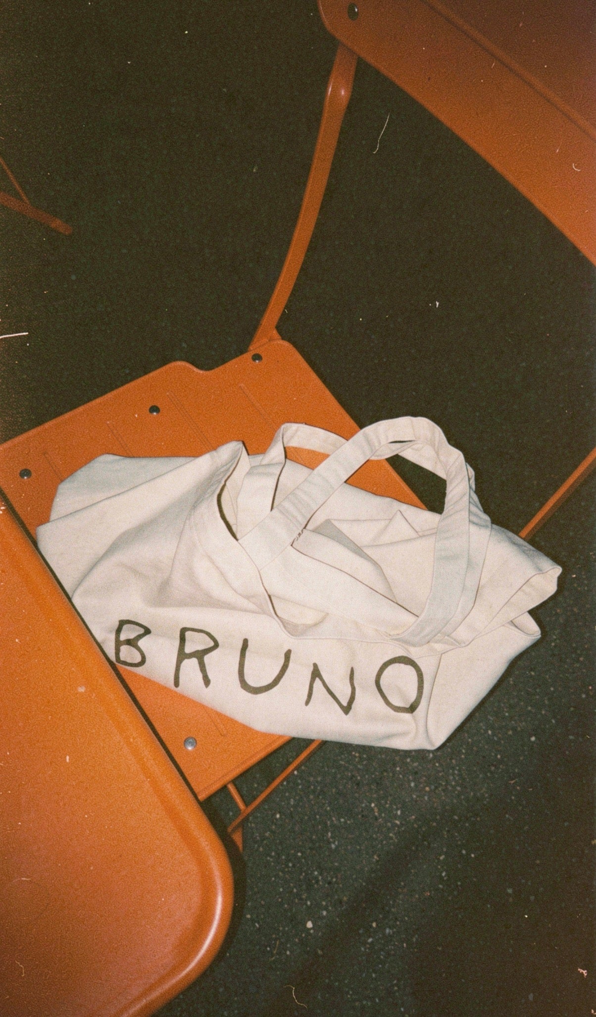 bruno canvas bag on orange chair
