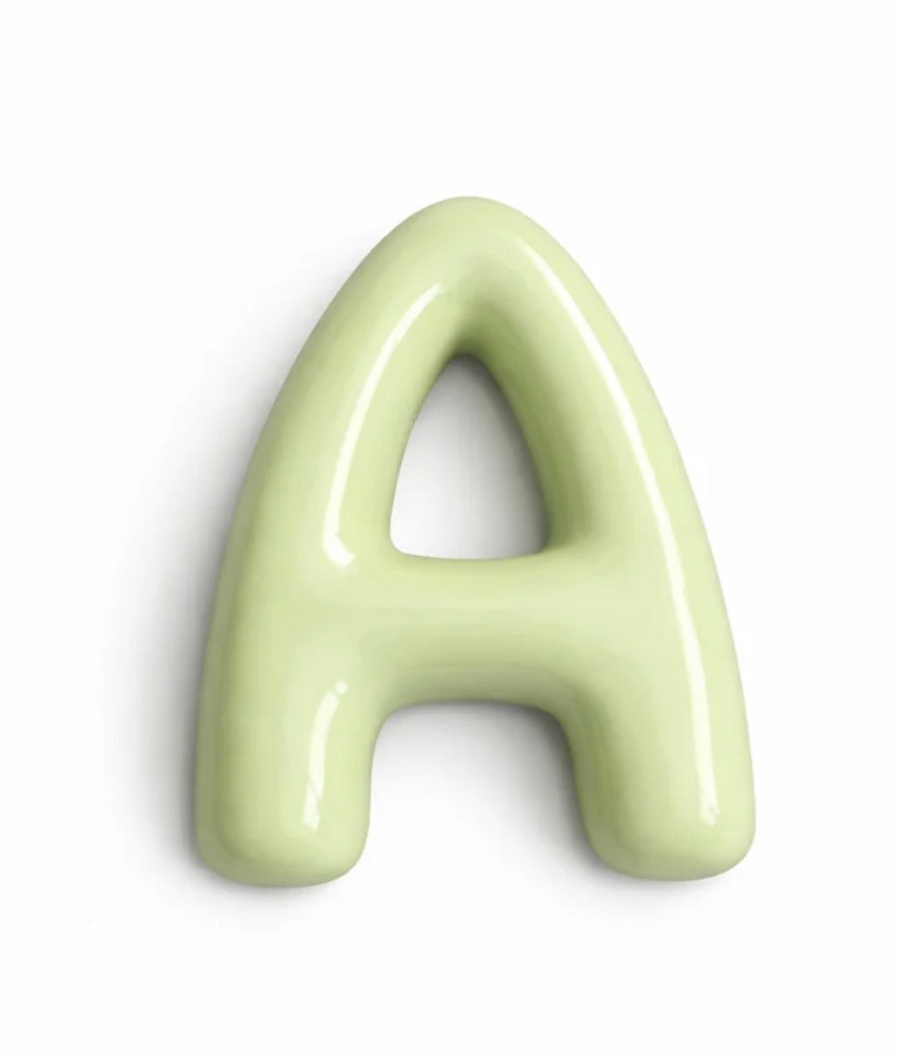 A glossy, light green ceramic letter 'A' on a clean white background.