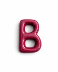 A glossy, 3D letter 'B' in a deep magenta pink color, shown on a clean white background with a soft drop shadow.