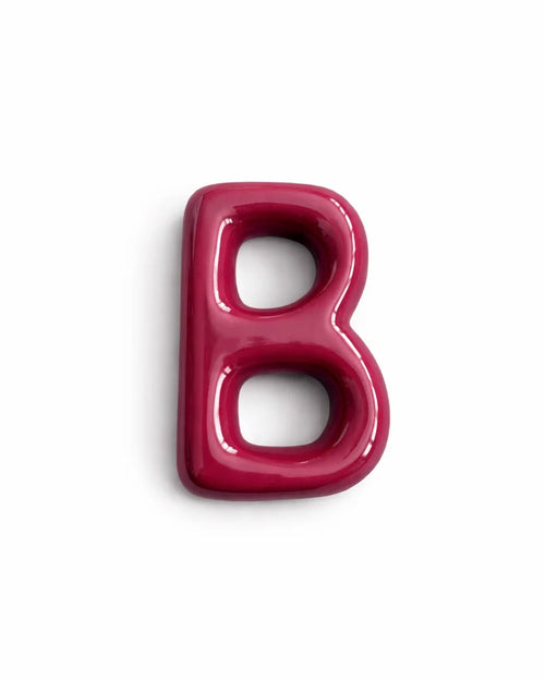 A glossy, 3D letter 'B' in a deep magenta pink color, shown on a clean white background with a soft drop shadow.