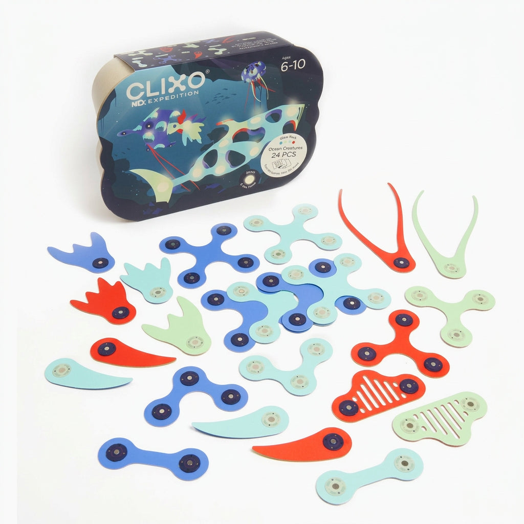 A set of colorful wooden fidget toys with central eye details, shown scattered on a white background with their branded storage box behind them. The box reads CLIXO and shows cartoon fish artwork.