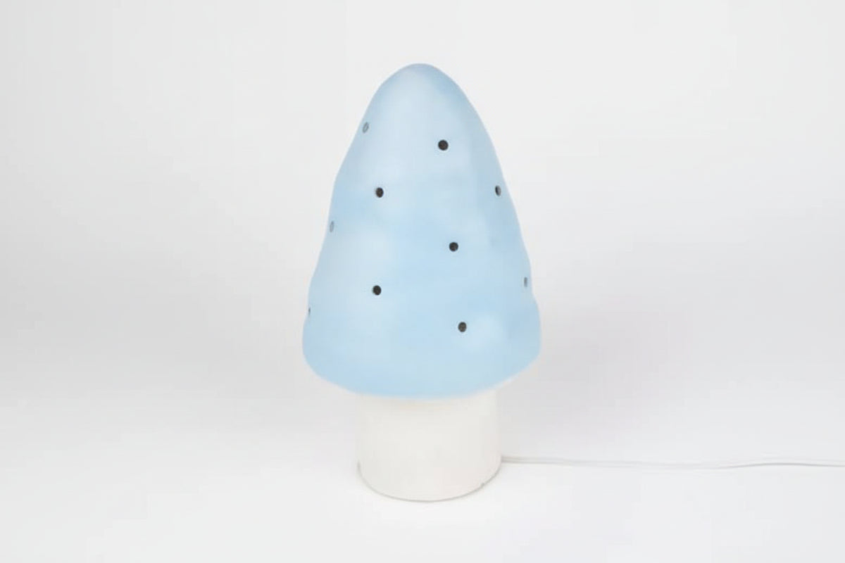 A mushroom-shaped decorative lamp or figurine in light blue with small black dots and the text 'harlekijn import b.v.