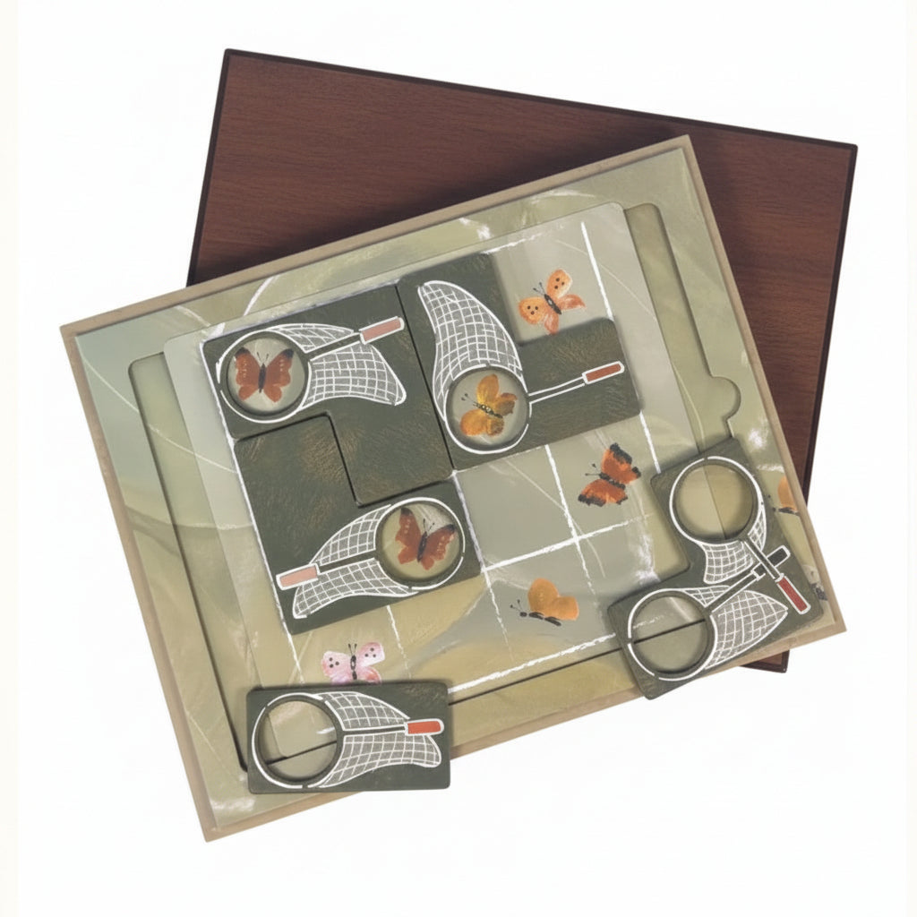 A square decorative craft or scrapbook board with butterfly and moth illustrations, circular cutouts, and layered paper elements, shown on a white background.