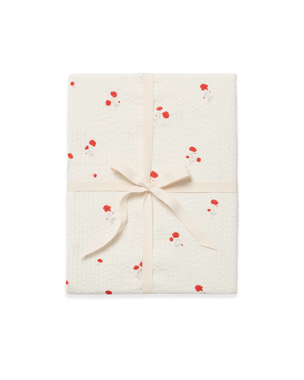 A gift-wrapped package featuring textured cream wrapping paper with a red and white floral pattern, tied with a matching cream satin ribbon in a bow, set against a plain white background.