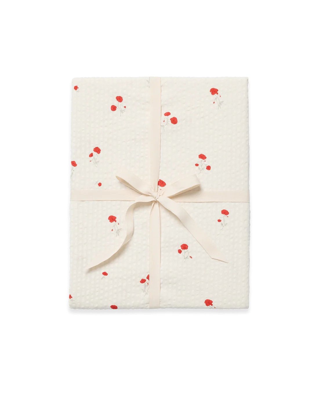 A gift-wrapped package featuring textured cream wrapping paper with a red and white floral pattern, tied with a matching cream satin ribbon in a bow, set against a plain white background.