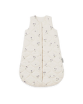An off-white quilted baby sleep sack with a small purple floral pattern, featuring a front zipper closure and a side tag.