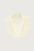 cream-colored baby bib with snap closures at the top, shown flat against a light gray background.