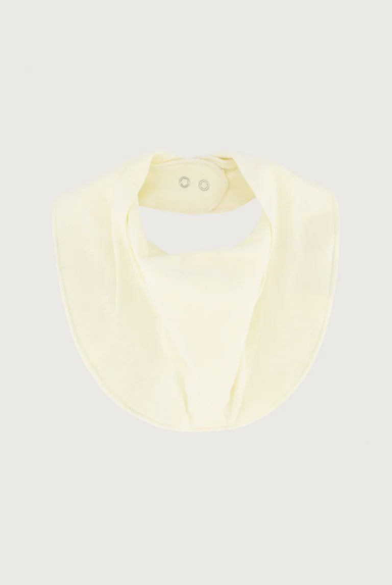 cream-colored baby bib with snap closures at the top, shown flat against a light gray background.