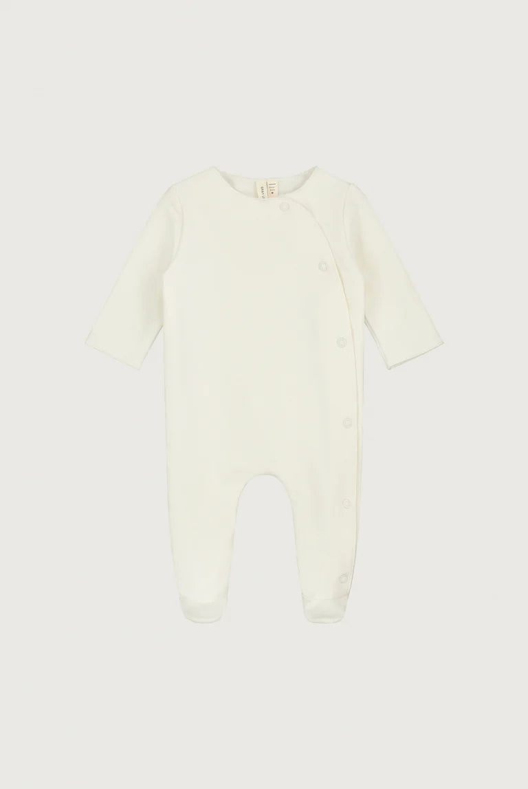 Cream-colored baby onesie on a white background