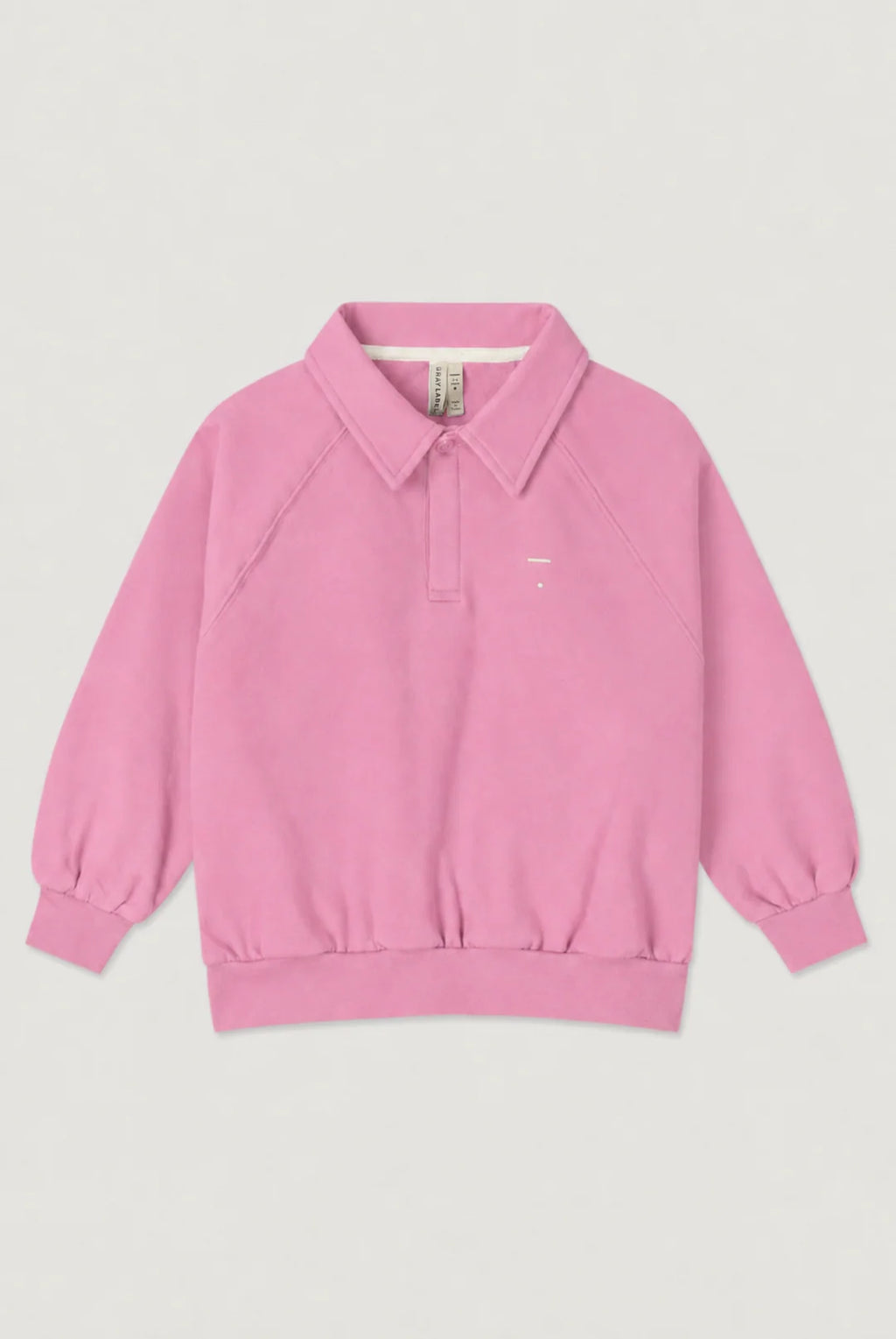 A pink long-sleeve polo sweatshirt with a collar and button placket, laid flat against a light gray background.