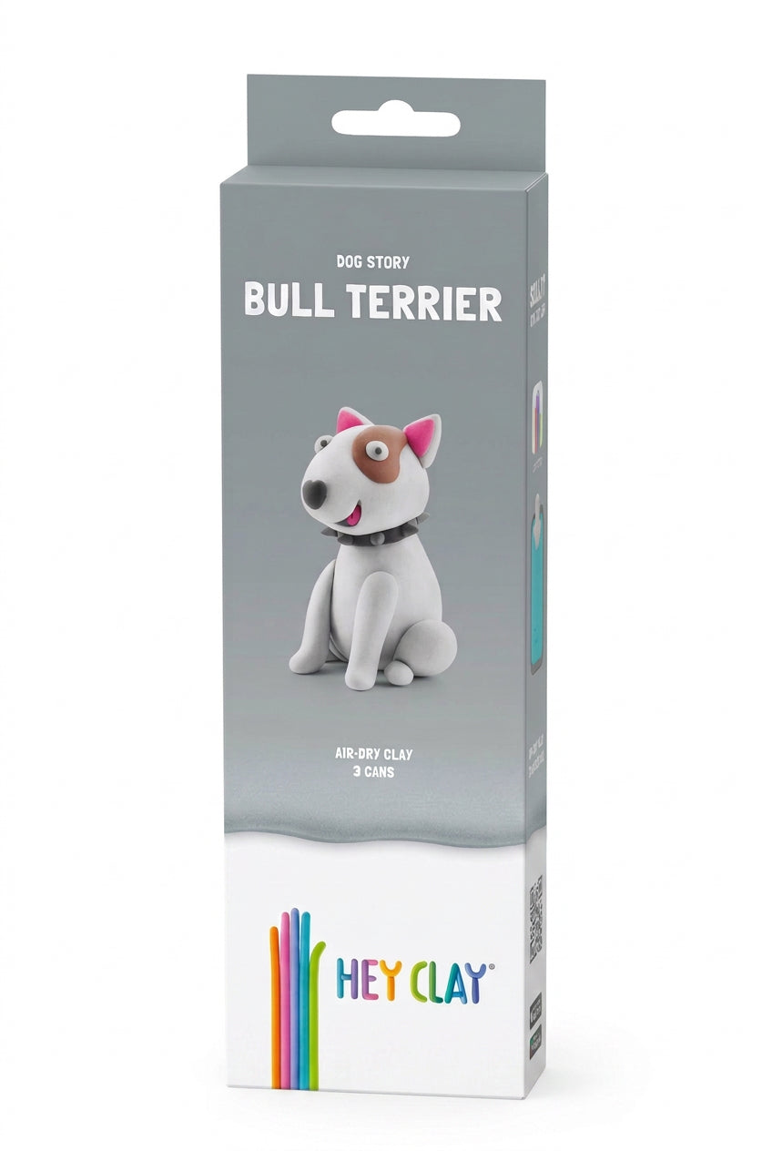Front view of the retail packaging for a Hey Clay air-dry clay figurine of a Bull Terrier from the 'Dog Story' collection. The packaging features a gray top half and a white bottom half with the Hey Clay logo.
