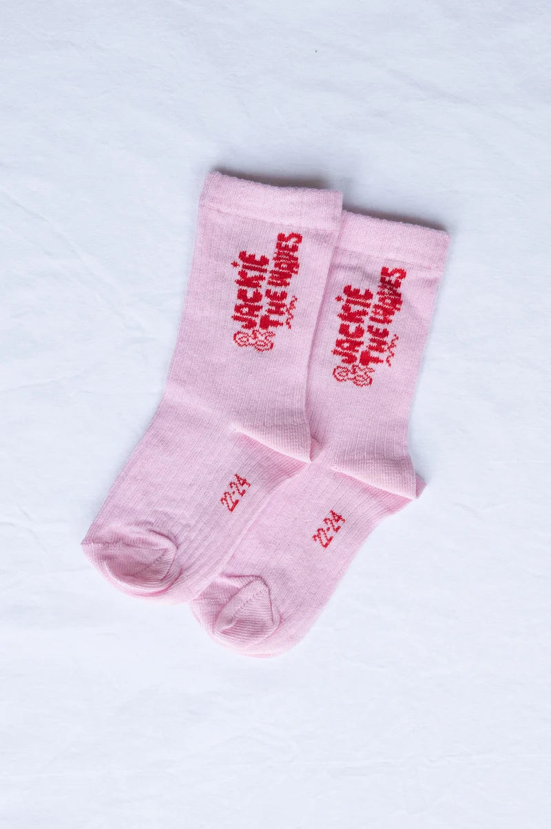 A pair of light pink crew socks with red embroidered text reading 'Jackie DeLuces' and the number '224' on a white background.