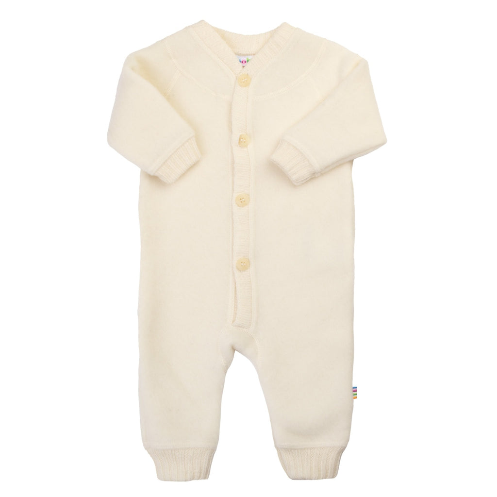 Cream-colored baby onesie with buttons on a white background