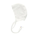 White baby bonnet with a strap on a white background