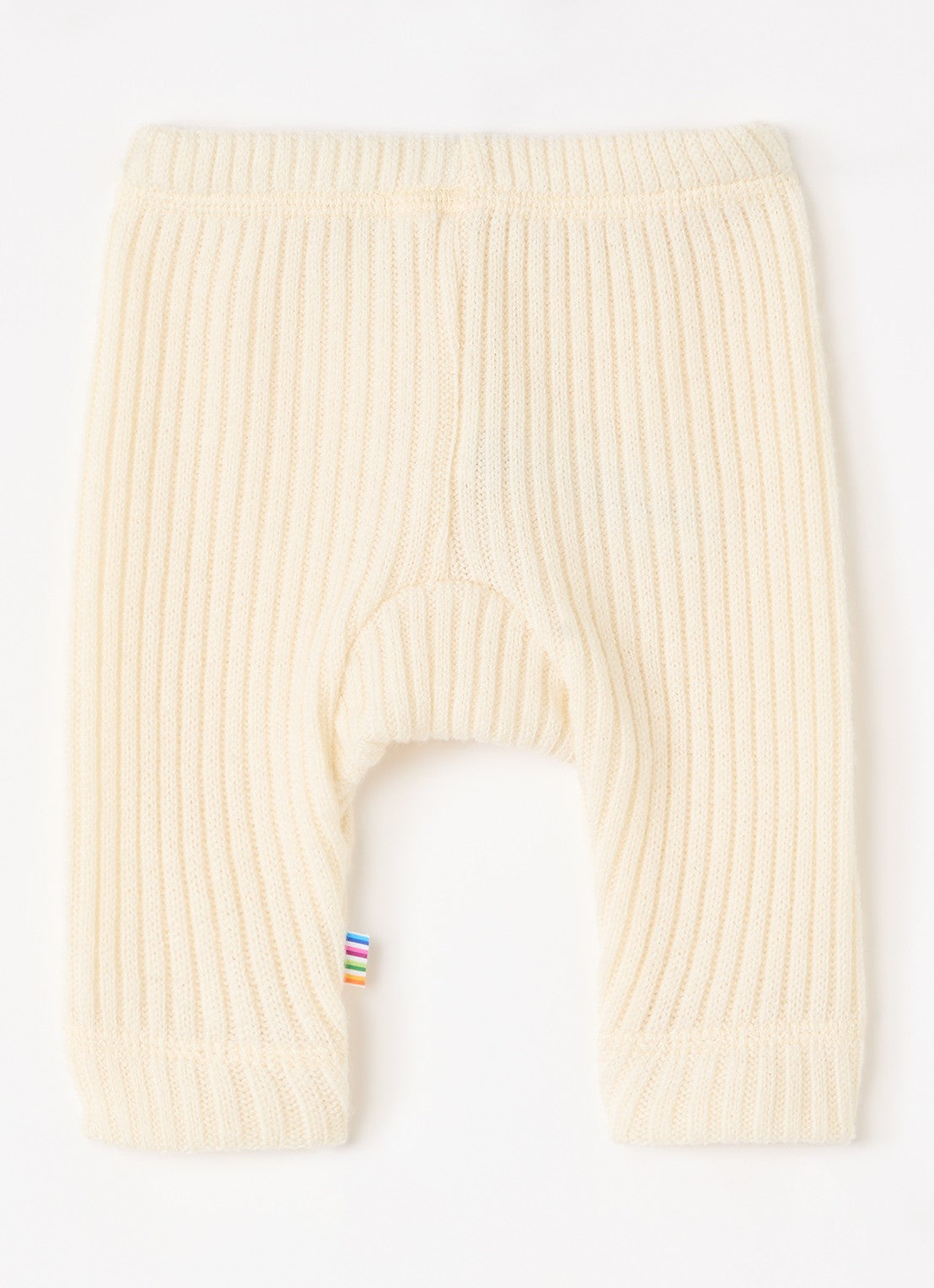 Cream ribbed knit baby leggings with a small colorful striped fabric tag near the lower left leg, shown flat on a white background.