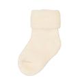 A single cream-colored fluffy faux fur sock with a wide ribbed cuff, shown against a plain white background.