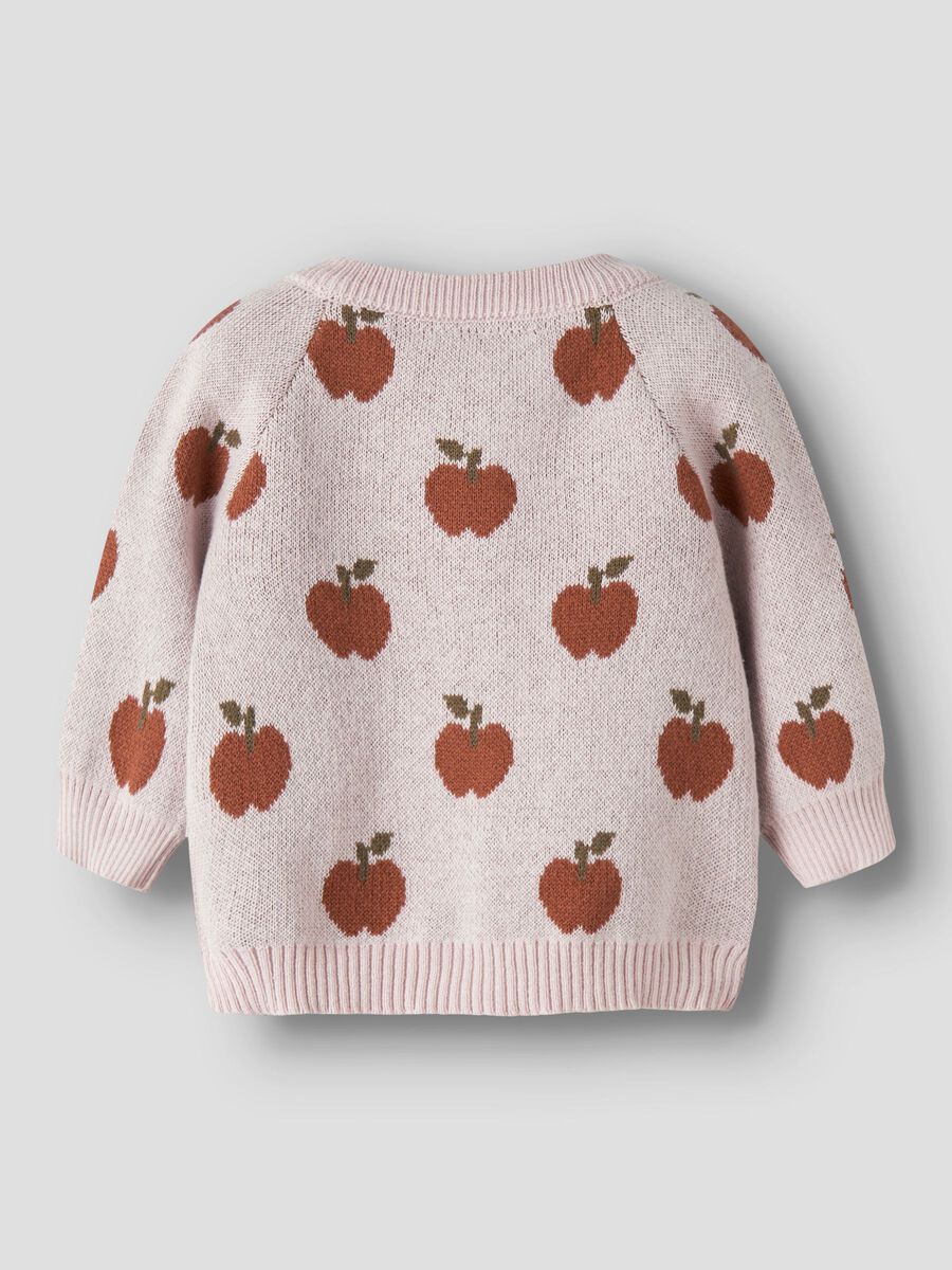 Pink sweater with apple pattern on a light gray background