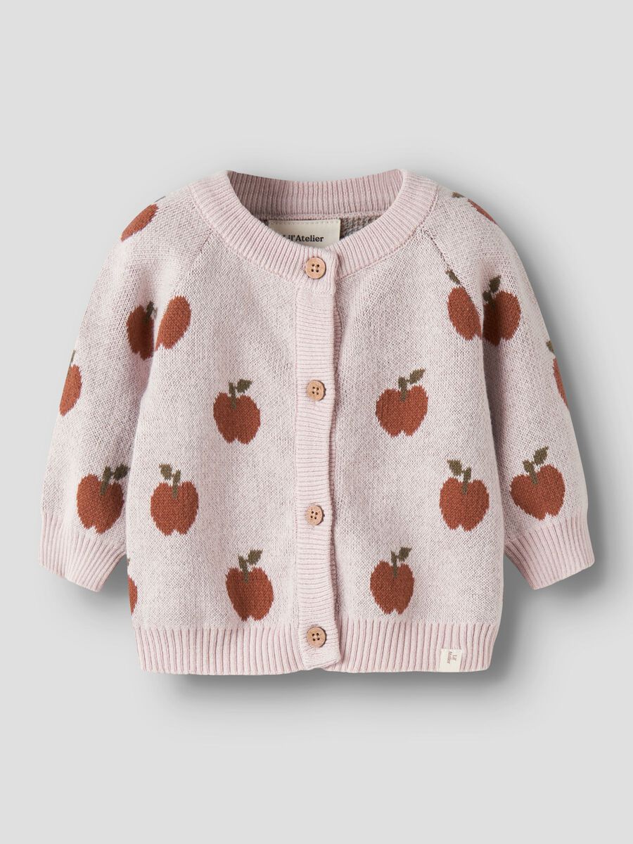 Pink knitted cardigan with apple pattern on a light gray background