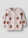 Pink knitted cardigan with apple pattern on a light gray background