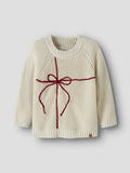 White sweater with a red bow on a plain background
