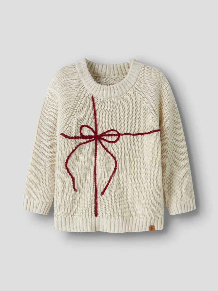 White sweater with a red bow on a plain background