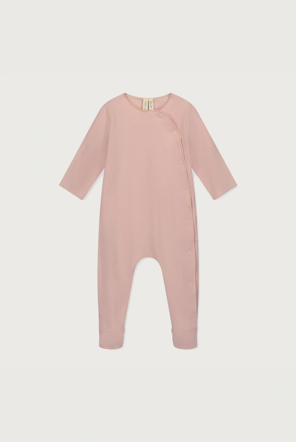 A baby long-sleeve footless jumpsuit in dusty pink, featuring an asymmetrical snap closure at the neckline, shown against a light gray background.