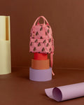 Pink backpack with brown  patterns on a brown background