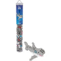 A small shark-shaped building block toy shown beside its clear cylindrical packaging tube on a white background. The tube has a blue label with shark graphics and the brand name Blue Beasts.