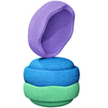 Three textured foam pet toys stacked vertically on a white background, with the top purple toy leaning against the others.
