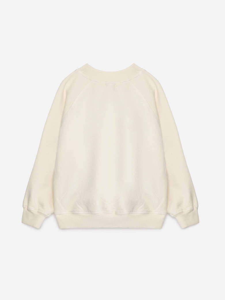 An off-white crewneck sweatshirt with long raglan sleeves and ribbed cuffs, hem, and collar, shown from the back on a light gray background.