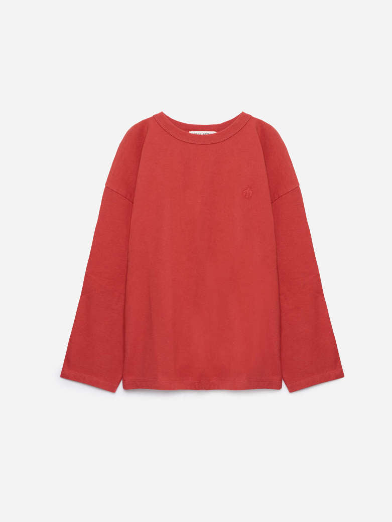A red long-sleeve crewneck sweatshirt with a small tonal embroidered logo on the left chest, displayed on a clean light gray background.