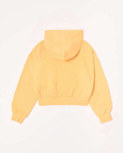 A pale yellow cropped hoodie shown from the back, featuring a drawstring hood, long sleeves with ribbed cuffs, and a ribbed hem, laid flat against a white background.