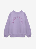 A light purple crewneck sweatshirt with 'TRUE ARTIST' printed in a matching purple arched font across the chest, displayed on a clean off-white background.