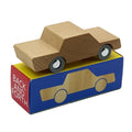 A wooden toy car with a natural wood body and black wheels, resting on top of its blue, yellow, and red branded box that reads 'BACK AND FORTH'.