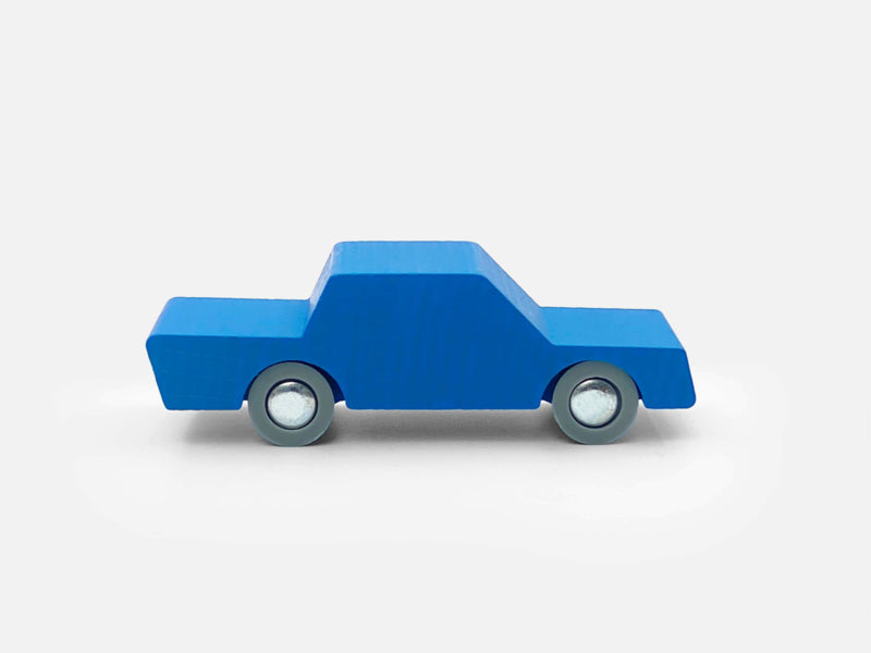Blue toy truck on a light gray background