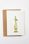 A white greeting card featuring a watercolor illustration of a duck wearing a party hat, shown with a brown kraft envelope on a clean white background.