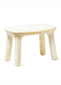 A vanilla table with a speckled yellow, orange, and blue resin pattern, shown on a clean white background.