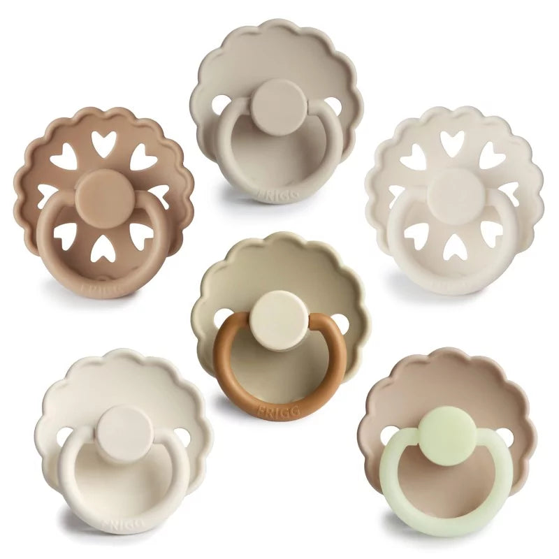 Set of six baby pacifiers in various colors on a white background