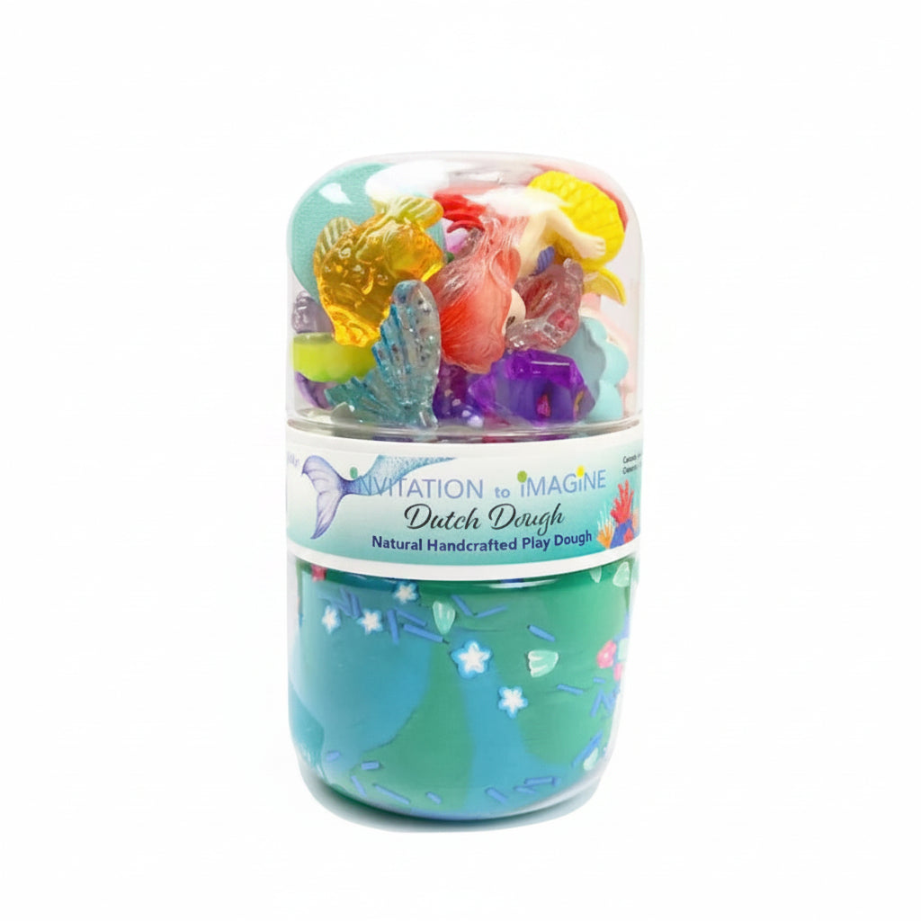 A stack of two Dutch Dough play dough containers on a white background. The top container is clear plastic showing colorful mermaid-themed play dough inside, and the bottom container is teal with an underwater scene design and small white starfish details.