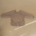 Children's long-sleeve shirt with Dino-pattern on a beige background