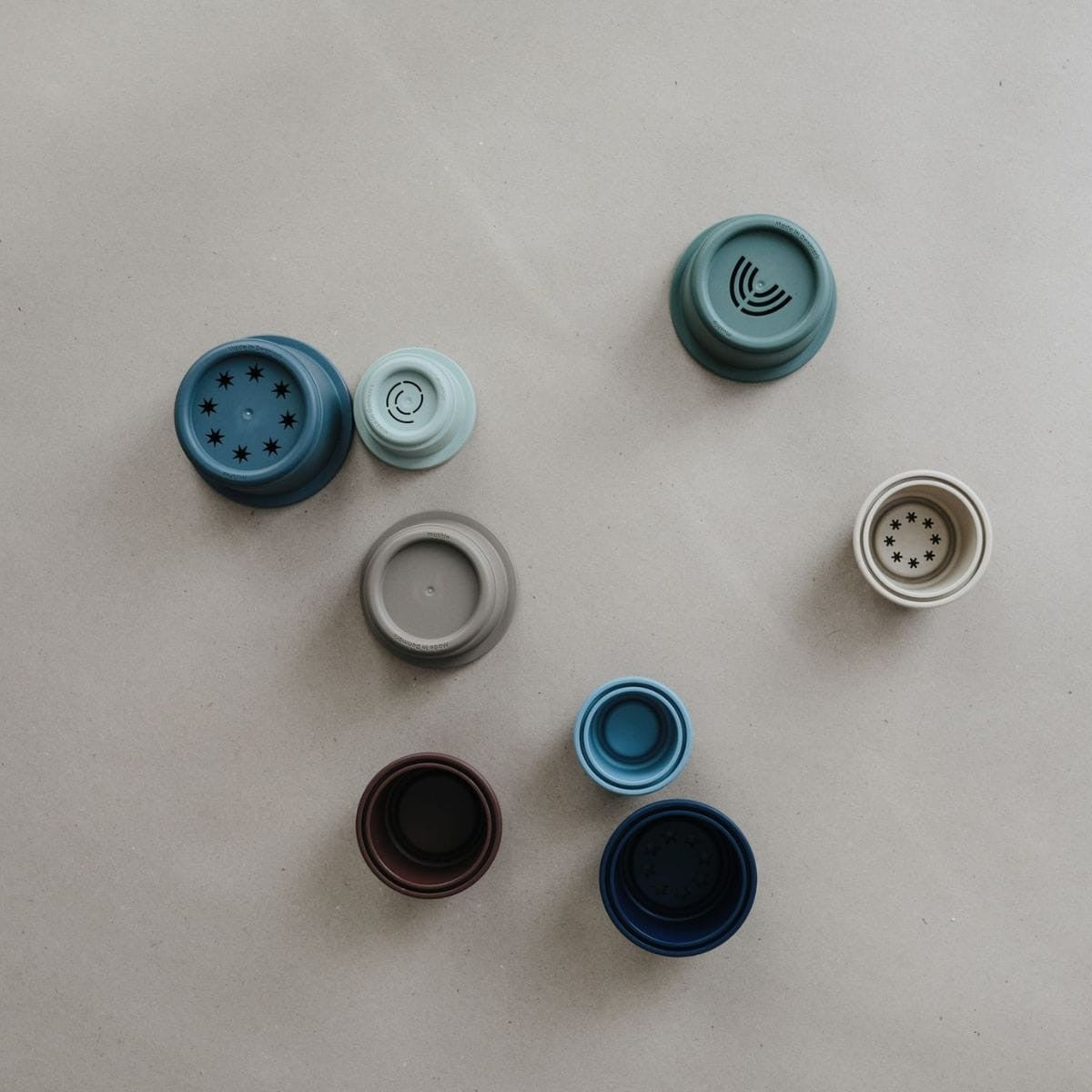 Collection of various bottle caps on a light gray background