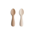 Two baby spoons on a white background