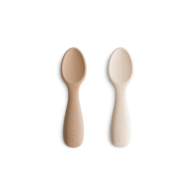 Two baby spoons on a white background